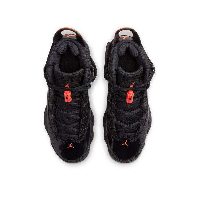 Pair of youth black high-top shoes with red lace details and orange outsole
