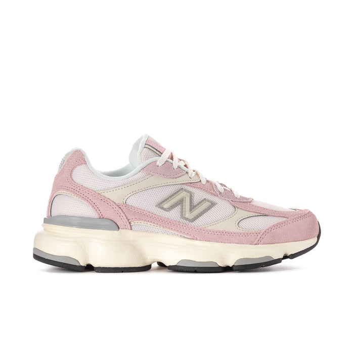 Women’s pink and white New Balance lace-up running sneakers with cushioned sole