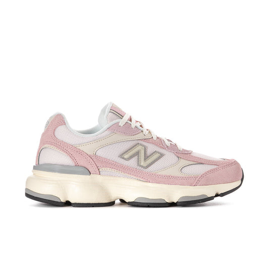 Women’s pink and white New Balance lace-up running sneakers with cushioned sole