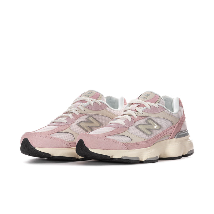 Women’s pink and white New Balance lace-up sneakers, side view with textured sole