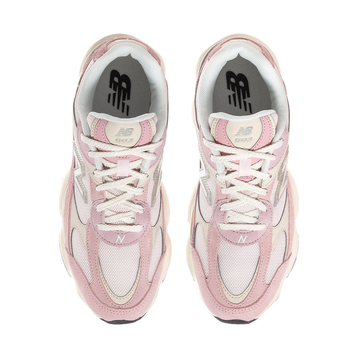 Women’s pink and white New Balance sneakers, front view with lace-up tongue and logo