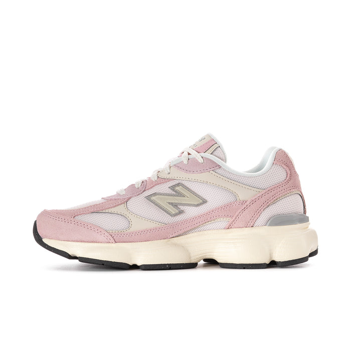 Women’s pink and white New Balance lace-up sneakers, angled side view