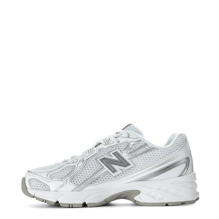 Women's white lace-up sneakers with metallic silver logo and thick midsole