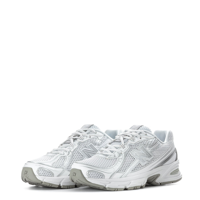 Pair of white lace-up sneakers with metallic silver logo, mesh upper, cushioned soles