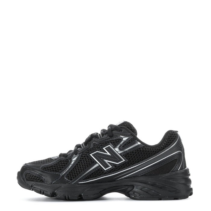 Youth black lace-up sneakers with bold silver N logo and textured midsole