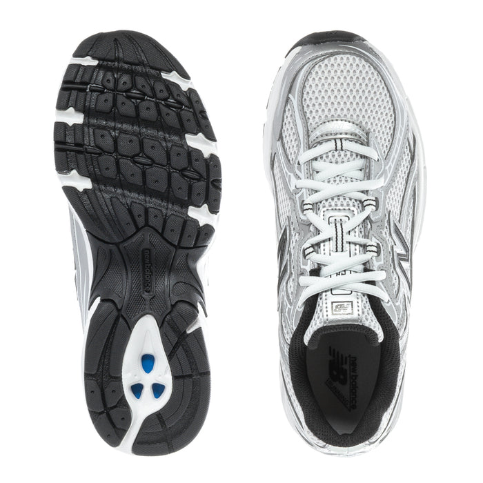 Silver youth running sneaker outsole view, black tread, white laces, black heel