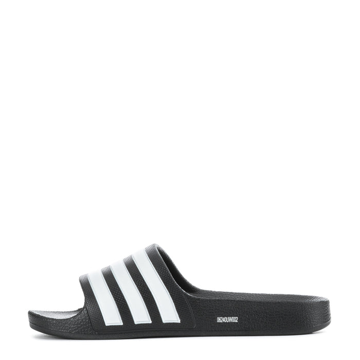 Kids black slide sandals with white triple stripes, side profile