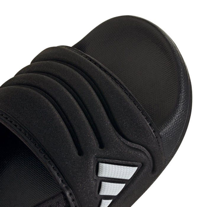 Close-up of black toddler slide sandal strap with white triple stripes logo