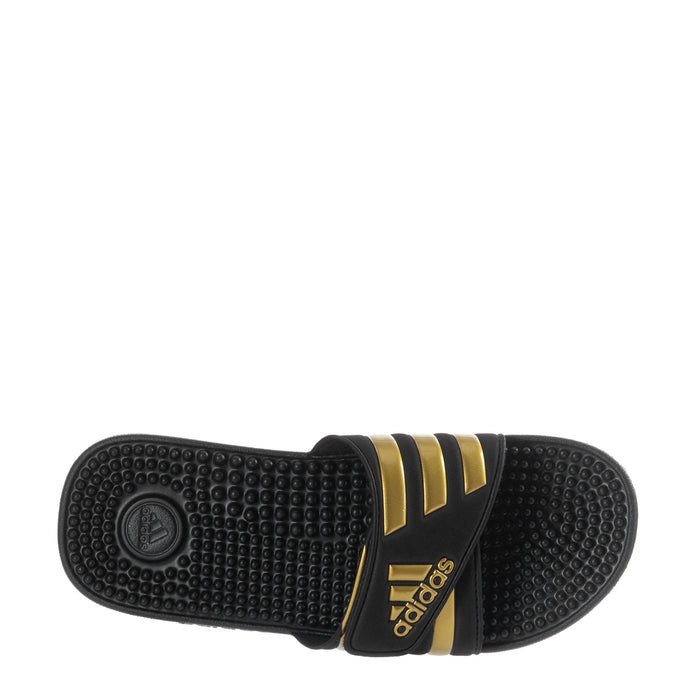 Men's black slide sandal outsole with textured tread and gold accent band