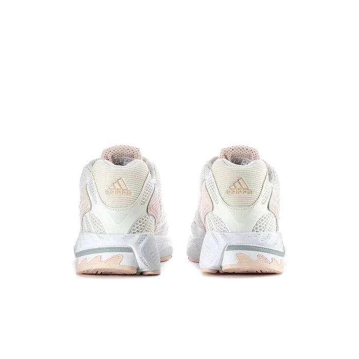 Women’s running shoes, back view; white heel with cushioned collar and light peach sole
