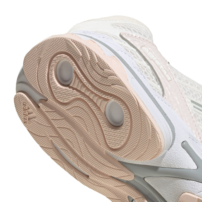 Women’s running shoes, close outsole view; tan tread with rounded traction pods