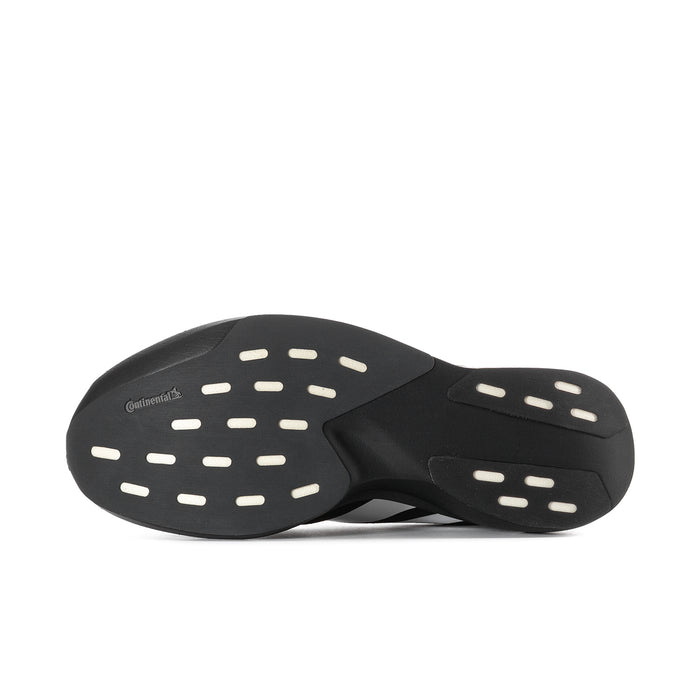Underside view of black running shoe outsoles with light-colored traction pads
