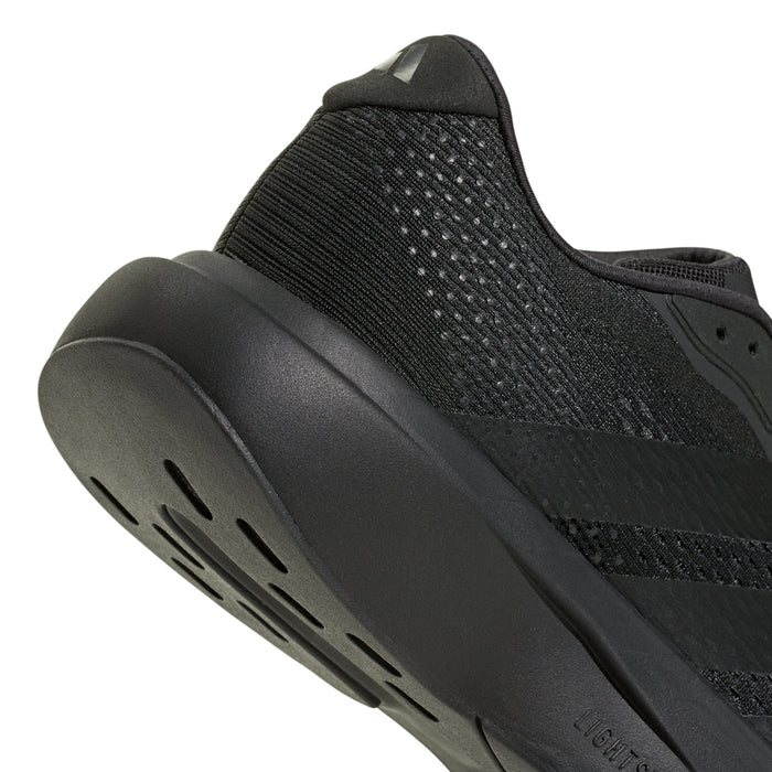 Men's black running shoe close-up of heel and side traction grooves