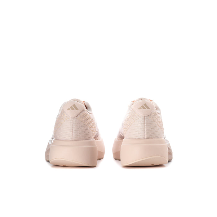 Women’s light pink running shoes viewed from heel with cushioned back and lace details.