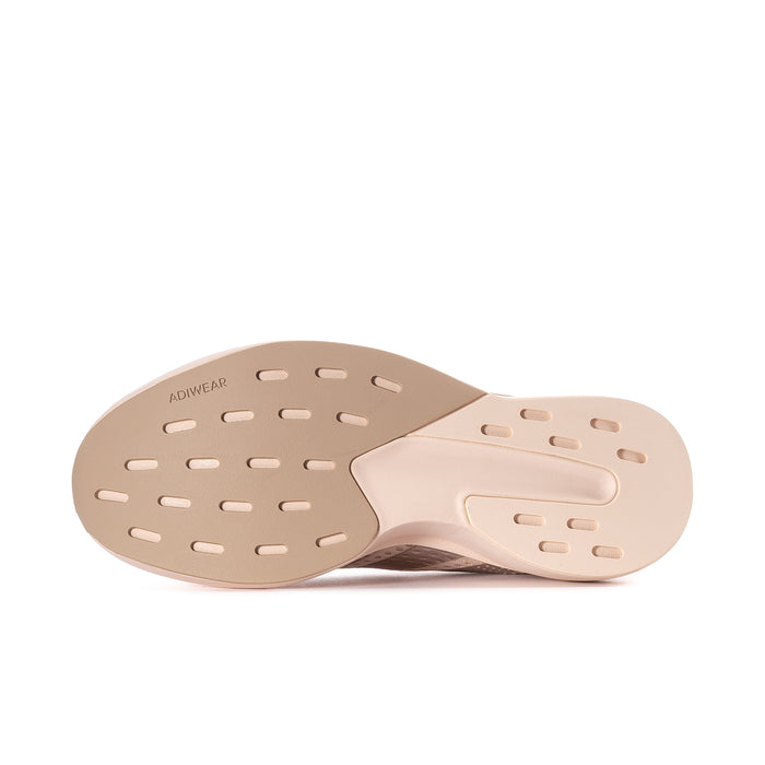 Women’s shoe outsole in light pink with molded tread pattern for grip.