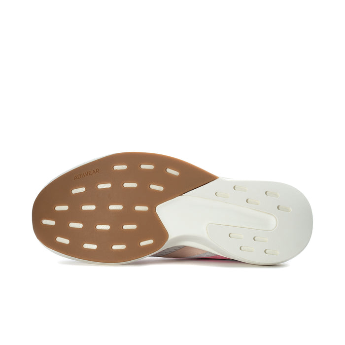 Outsole view of women's grey running shoe with tan rubber pods and white heel panel
