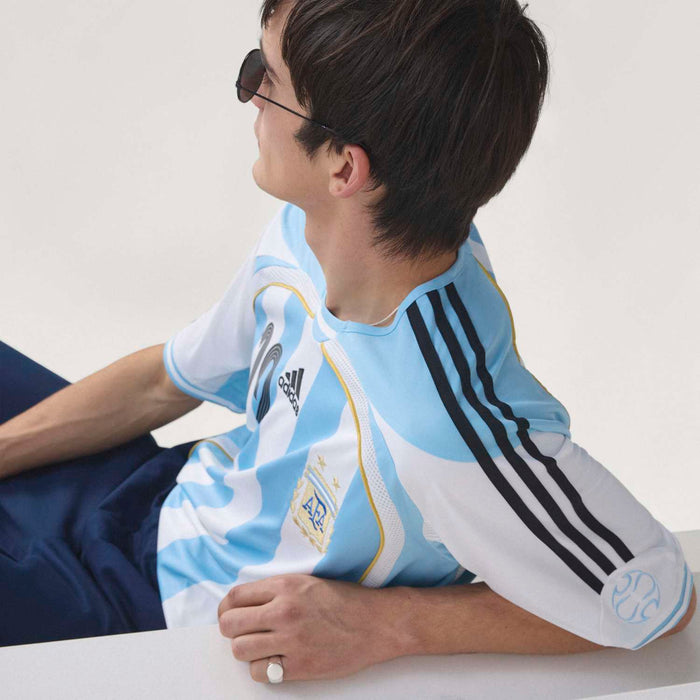 Men's AFA home jersey side view in light blue and white stripes with AFA crest