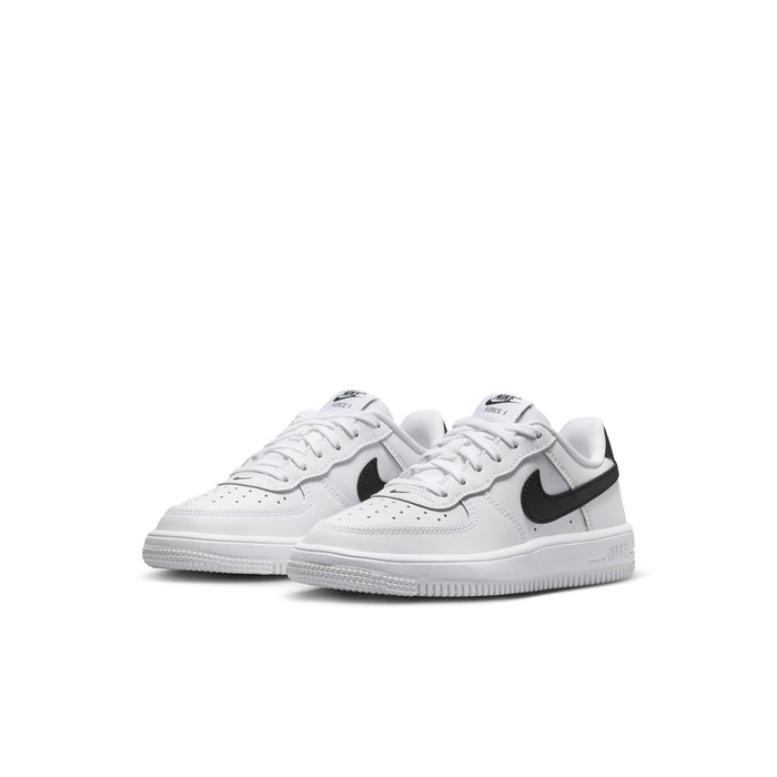 Kids' white low-top sneakers with black swoosh, lace-up, side view of pair