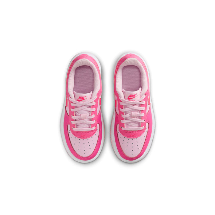 Kids pink Nike sneakers, top view with lace-up, white eyelets, and padded interior