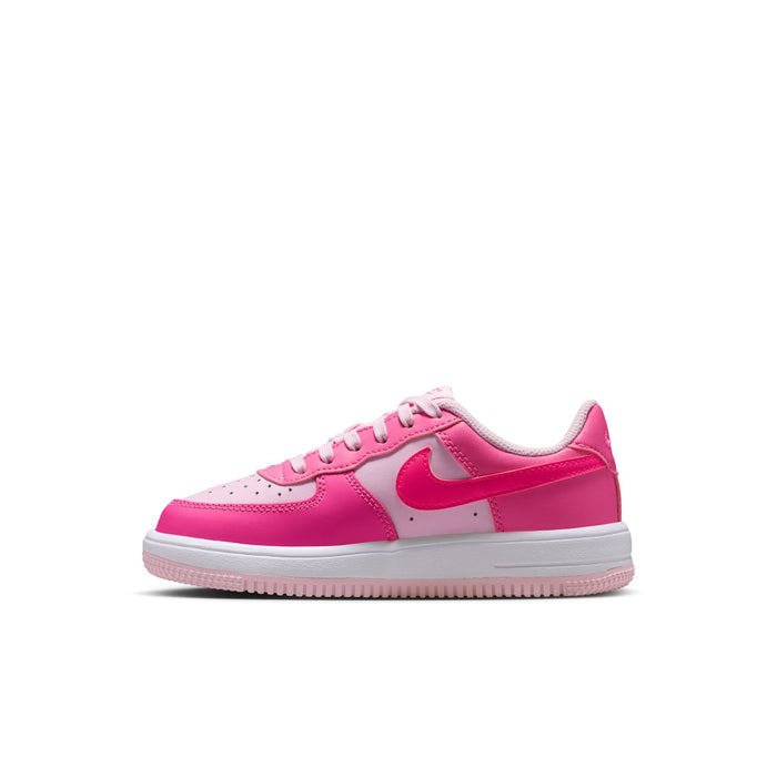 Kids pink Nike Air Force 1-style sneaker side profile with white Swoosh and lace-up tongue