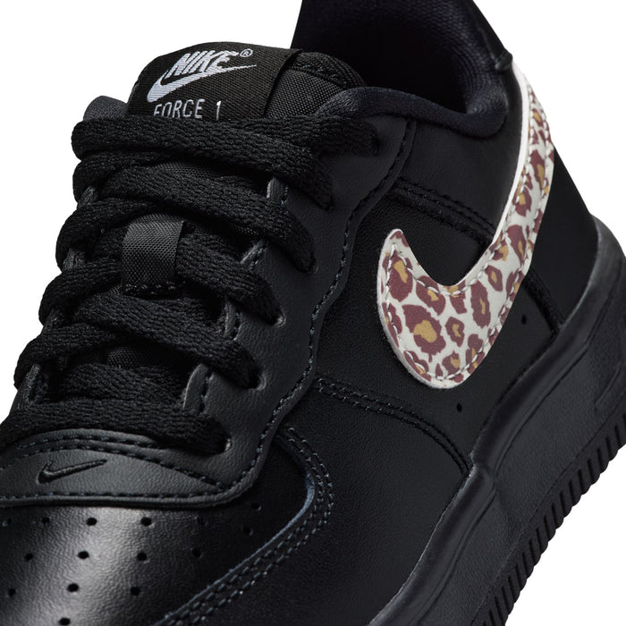 Close-up of kids Nike Air Force 1 tongue and laces, black with leopard heel panel