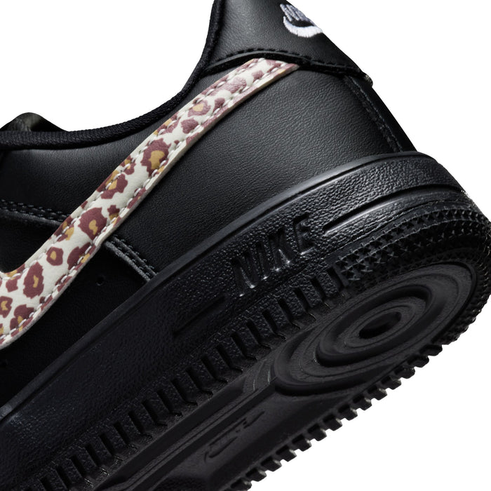 Close-up of kids Nike Air Force 1 midsole with black leather and leopard side strap