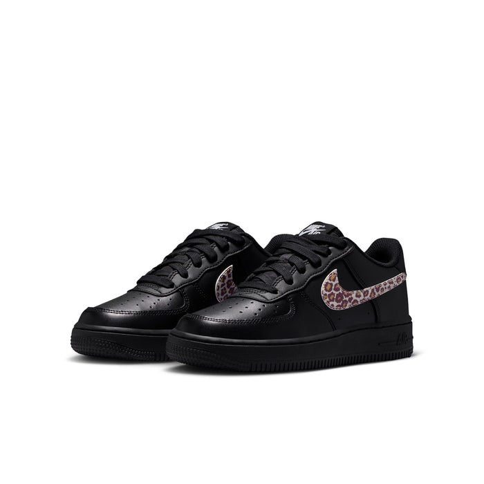 Pair of black youth low-top sneakers with leopard-print Nike Swoosh and black laces