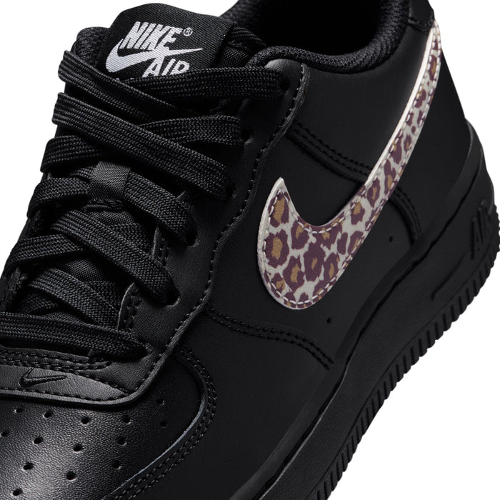 Close-up: black youth sneaker with leopard-print Swoosh and stitched leather panels
