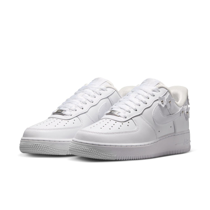 White Nike Air Force 1 sneakers, two-quarter view with laces, swoosh, and textured rubber sole