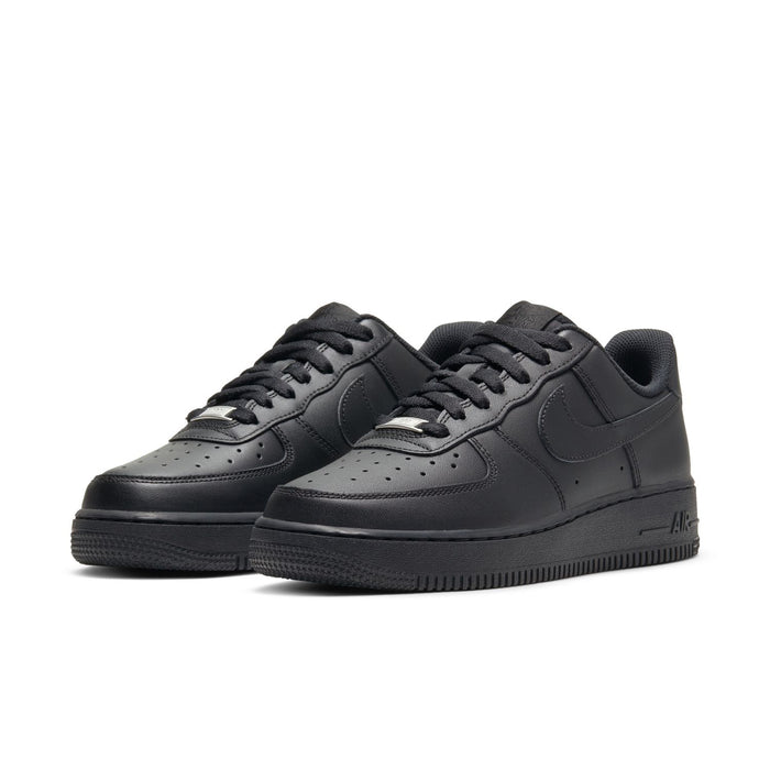 Pair of black women’s low-top sneakers, side profile with lace-up design