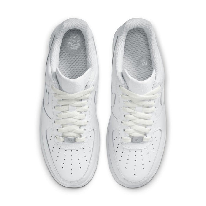 Women's white sneakers, close-up toe and laces with perforation details