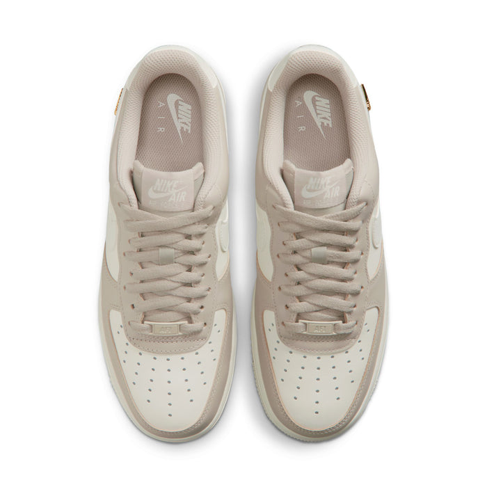 Pair of cream low-top sneakers viewed from toe and tongue, lace-up front
