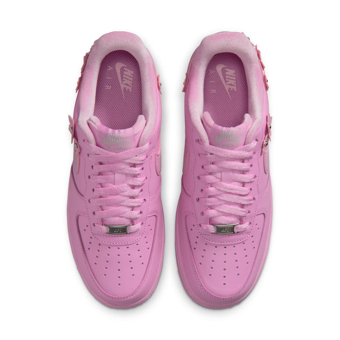 Pink low-top sneakers viewed from above with lace holes and perforated toe