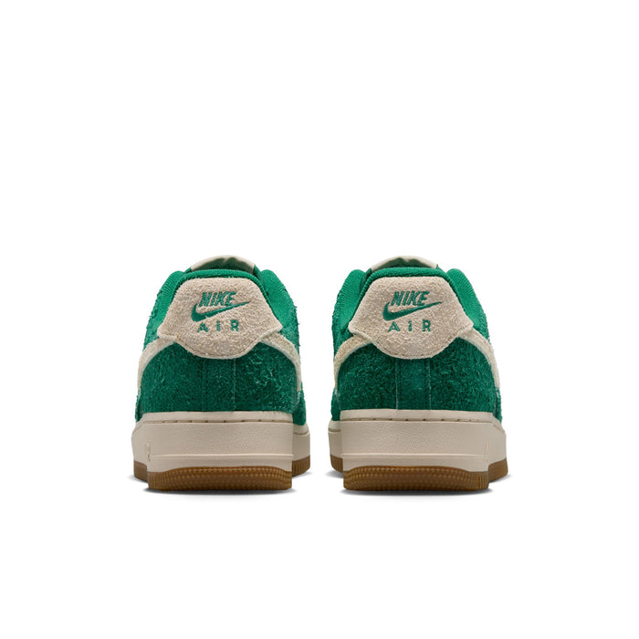 Women’s green low-top sneakers with beige heel tabs and gum outsoles