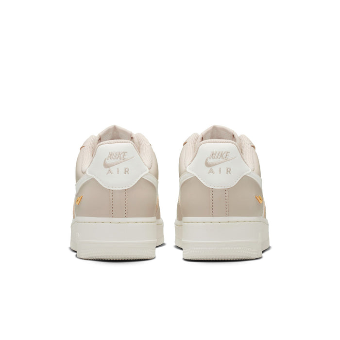 Cream low-top sneakers from heel with Nike Air branding and lace-up closure