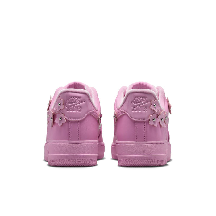 Pink low-top sneakers from back with lace-up collar and padded heel