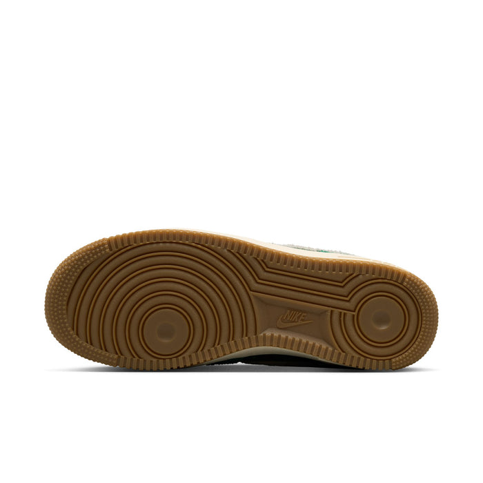 Bottom view of women’s green low-top sneakers with gum outsole and Nike logo