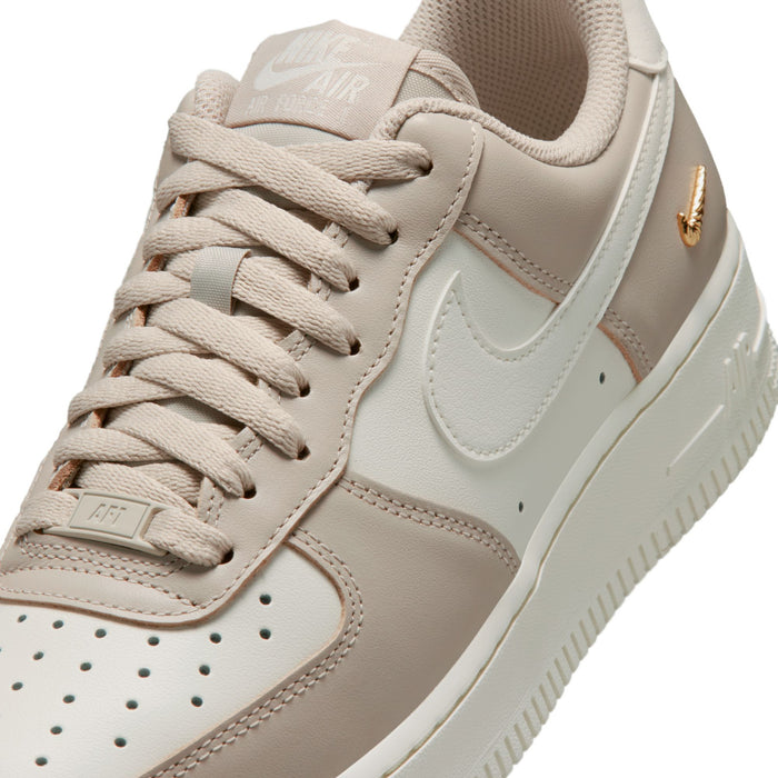 Close-up of cream and tan sneaker upper with lace stitching and Nike Swoosh