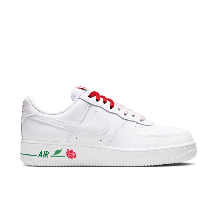 Women's white low-top sneaker with red laces, green trim, and rose Air detail