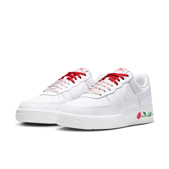 Pair of women's white low-top sneakers with red laces and green-and-rose side accents