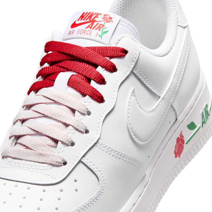 Close-up of women's white sneaker toe and laces with red branding detail