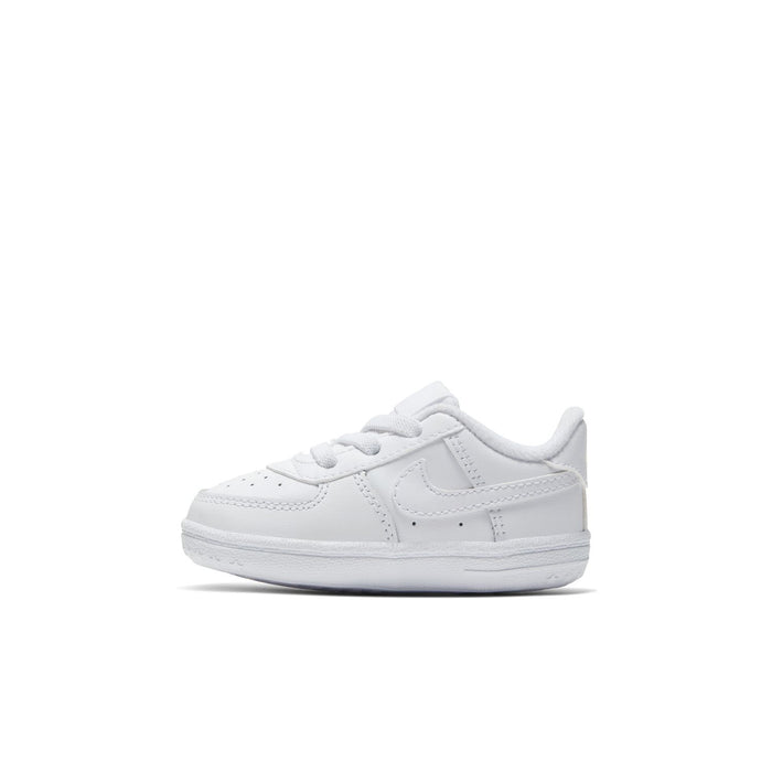 Infant white low-top sneakers, front angled view, lace-up and swoosh logo