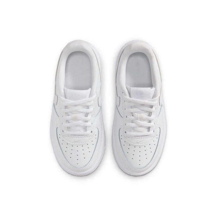 Kids' white low-top sneakers pair viewed from above, laces and perforated toe