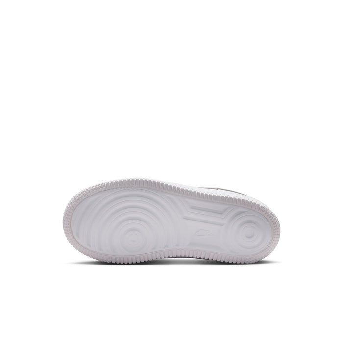 Kids' white sneaker outsole with textured rubber tread pattern
