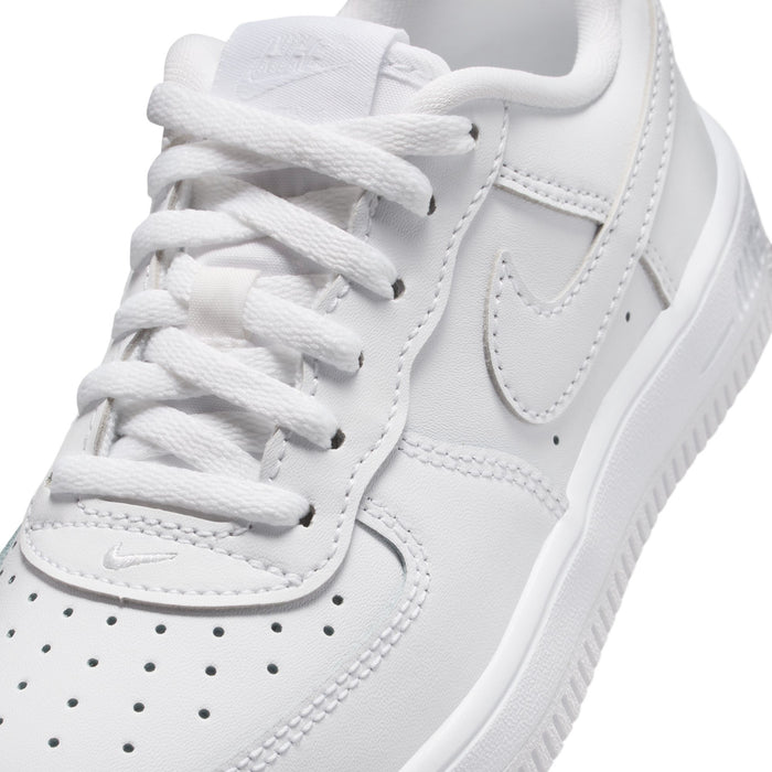 Kids' white low-top sneakers close-up, laces and Nike swoosh on upper