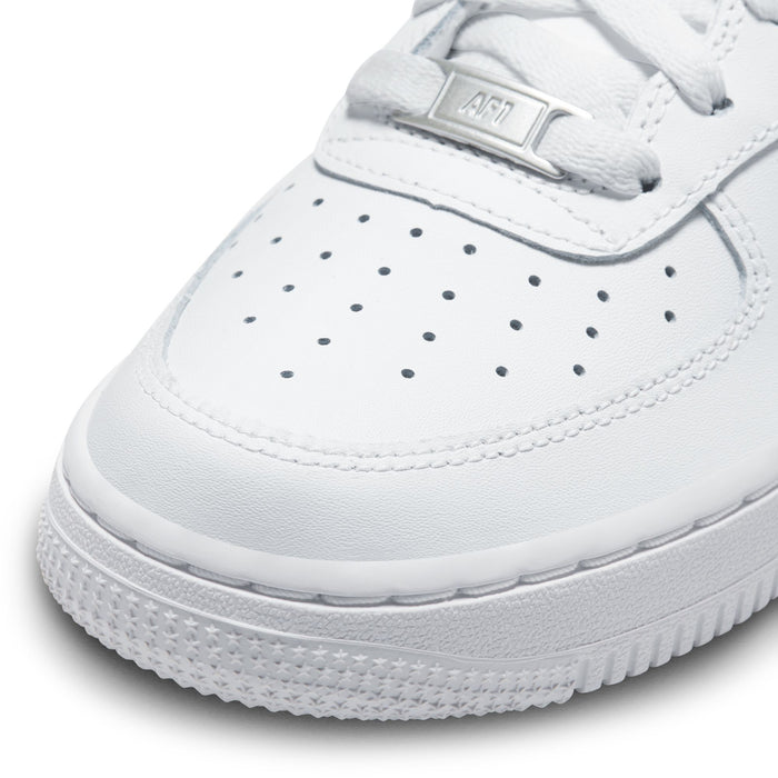 Close-up youth low-top sneaker toe, white leather with perforations and lace-up