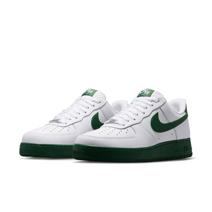 Pair of men's white low-top sneakers with green swooshes and dark green soles.