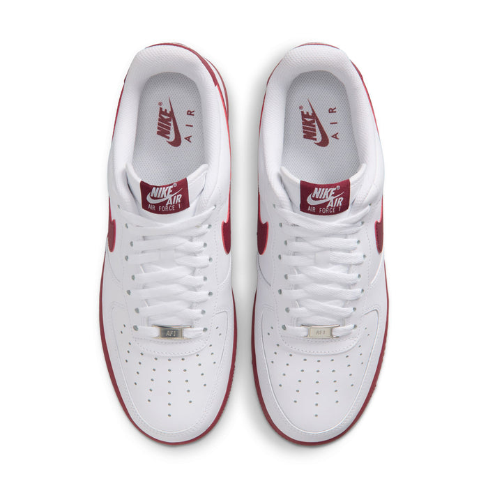 Men's white Nike Air Force 1 sneakers, top view of laces and perforated toe