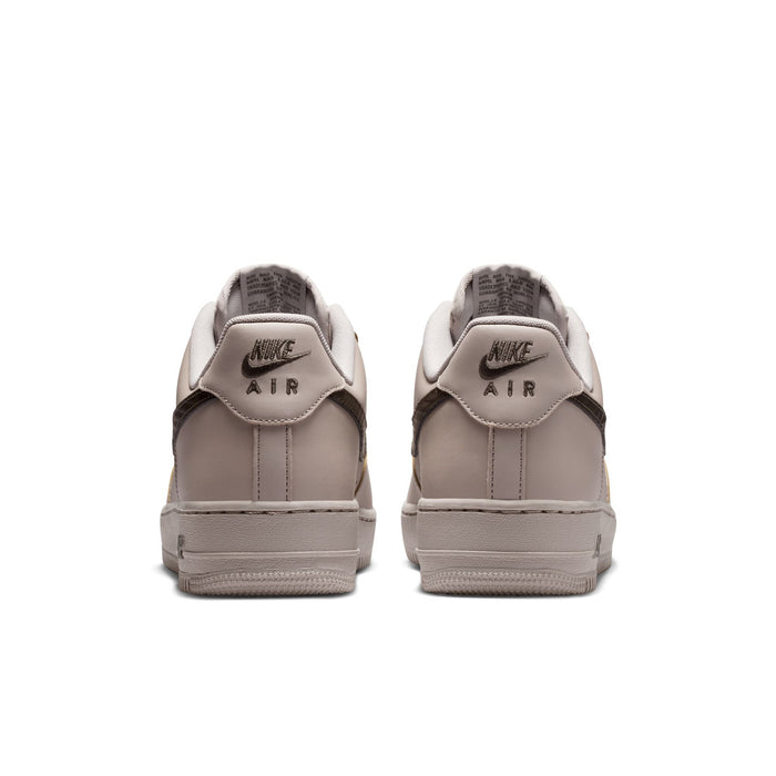 Men's low-top sneakers, heel view, light beige leather with Nike Air logo on insole