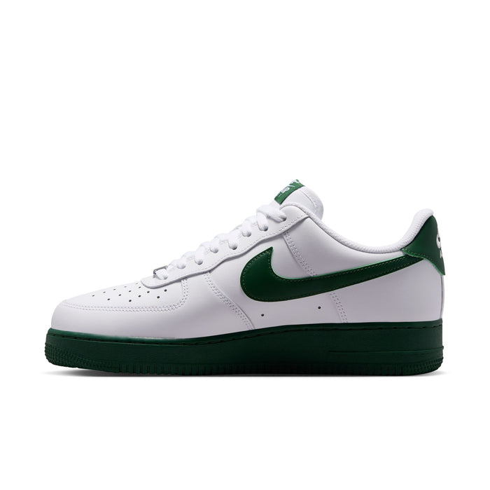 Men's white low-top sneaker with green swoosh overlay and dark green cup sole.
